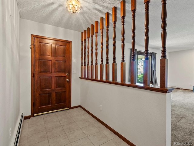 3780 W 66th Ave, Arvada, CO 80003 - entrance foyer with a baseboard heating unit, baseboards, a textured ceiling, and light tile patterned floors