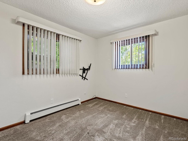 3780 W 66th Ave, Arvada, CO 80003 - spare room with a baseboard heating unit, carpet floors, baseboards, and a textured ceiling