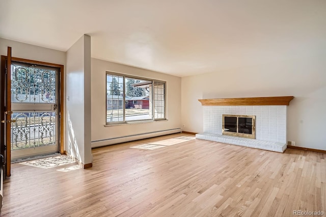 unfurnished living room featuring a fireplace, baseboards, a baseboard heating unit, and light wood-style floors