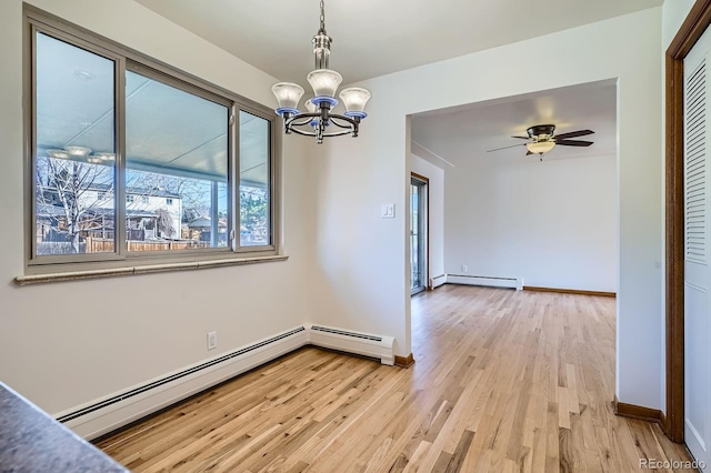 unfurnished dining area featuring a baseboard heating unit, baseboards, light wood-style floors, and ceiling fan with notable chandelier