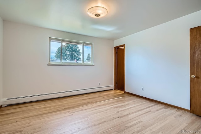 unfurnished room with a baseboard radiator, baseboards, and light wood-style flooring