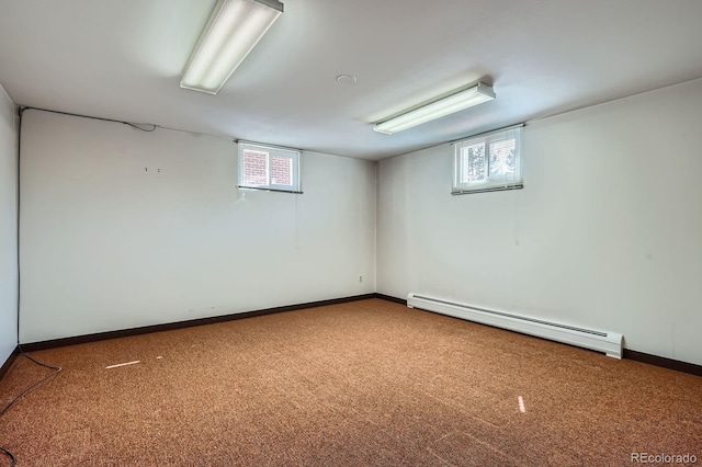 below grade area featuring baseboards, carpet floors, and a baseboard radiator