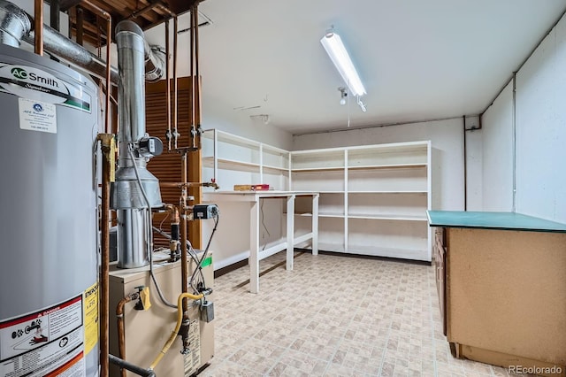 below grade area featuring gas water heater and light floors