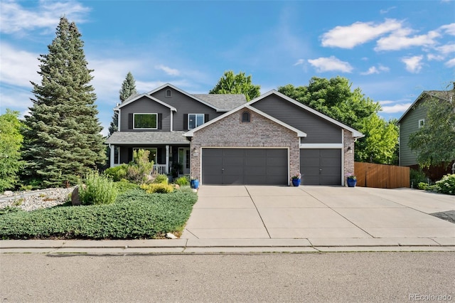 2066 Amber Ct, Erie, CO 80516 - view of front of house with brick siding, a garage, driveway, and a porch