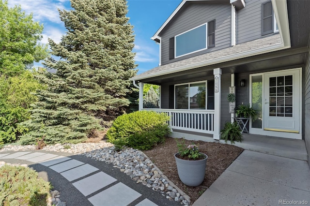 2066 Amber Ct, Erie, CO 80516 - entrance to property featuring covered porch and a shingled roof