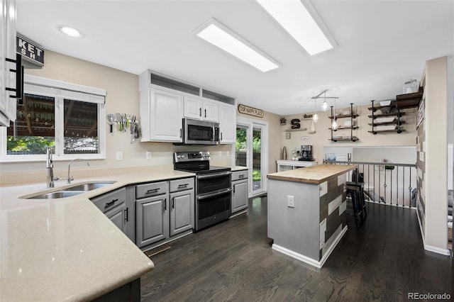 2066 Amber Ct, Erie, CO 80516 - kitchen with appliances with stainless steel finishes, butcher block countertops, dark wood-style flooring, gray cabinetry, and white cabinetry