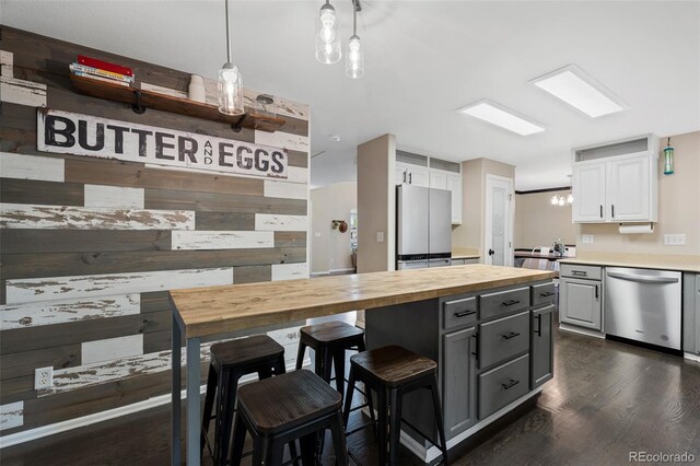 2066 Amber Ct, Erie, CO 80516 - kitchen featuring dishwasher, wood counters, white cabinets, dark wood-style floors, and gray cabinetry