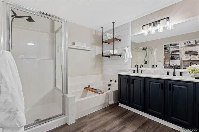 2066 Amber Ct, Erie, CO 80516 - bathroom featuring a shower stall, wood finished floors, a garden tub, and double vanity