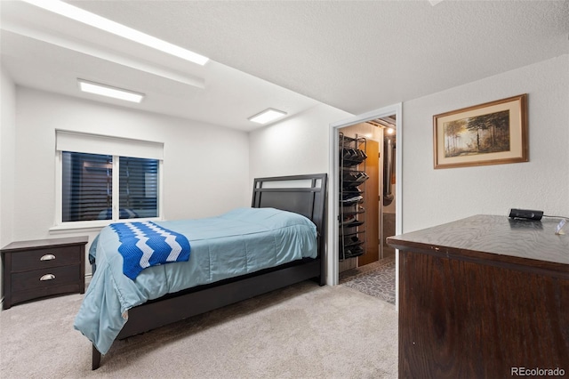 2066 Amber Ct, Erie, CO 80516 - bedroom featuring light colored carpet, a spacious closet, and a textured ceiling
