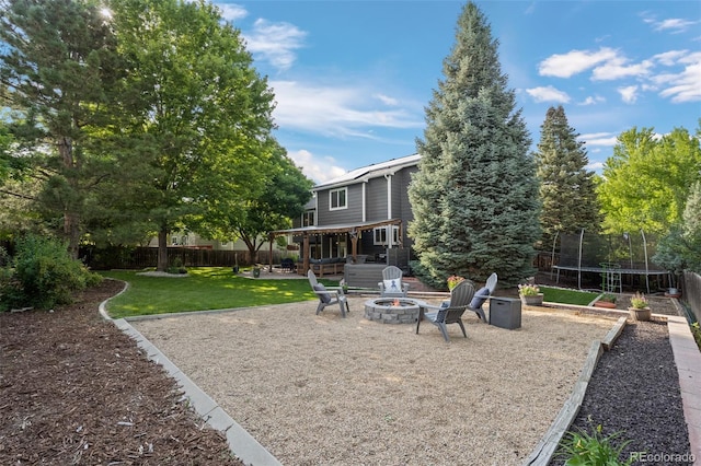 2066 Amber Ct, Erie, CO 80516 - view of yard with a trampoline, a fire pit, and a patio area