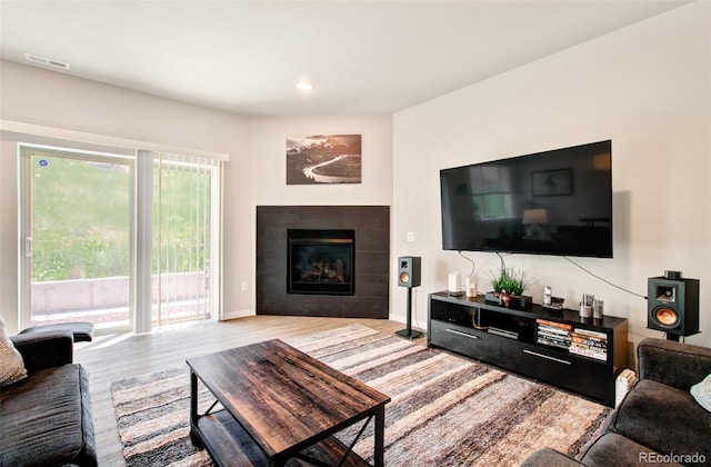 5477 Passport Vw, Colorado Springs, CO 80922 - living room with light wood-style floors, a fireplace, baseboards, and recessed lighting