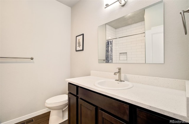 5477 Passport Vw, Colorado Springs, CO 80922 - full bathroom featuring vanity, toilet, curtained shower, wood finished floors, and baseboards