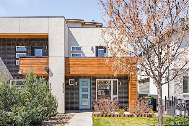 multi unit property with fence and stucco siding