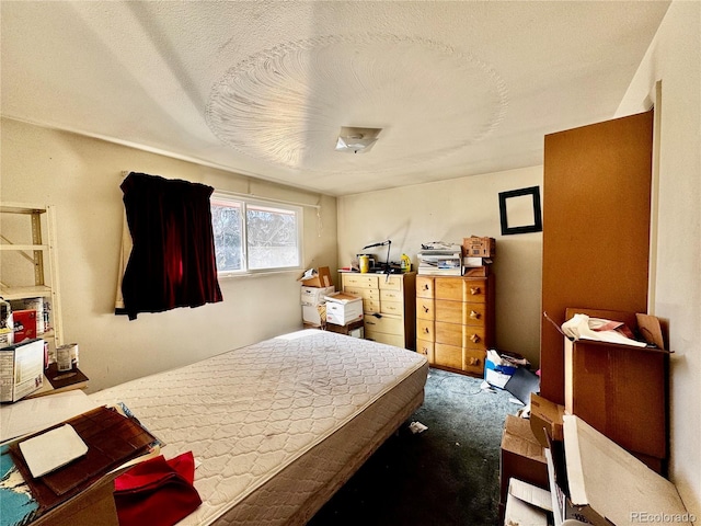 carpeted bedroom with a textured ceiling