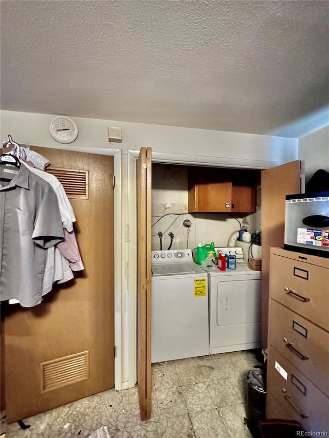 laundry area featuring laundry area, a textured ceiling, visible vents, and separate washer and dryer