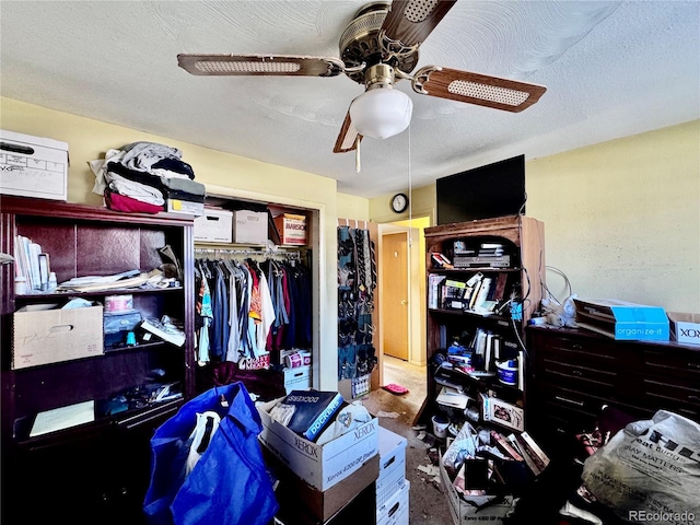 bedroom featuring ceiling fan, a closet, and a textured ceiling