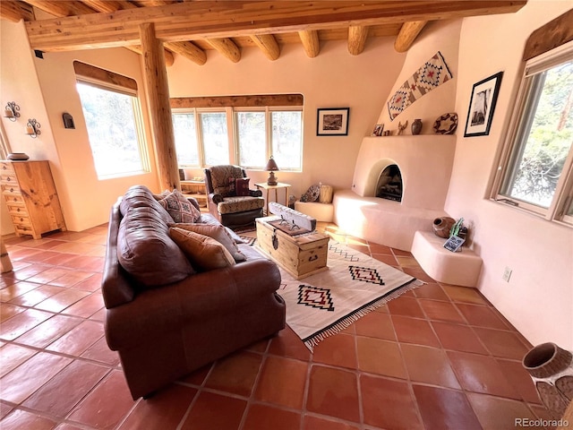 tiled living area featuring a healthy amount of sunlight and beamed ceiling