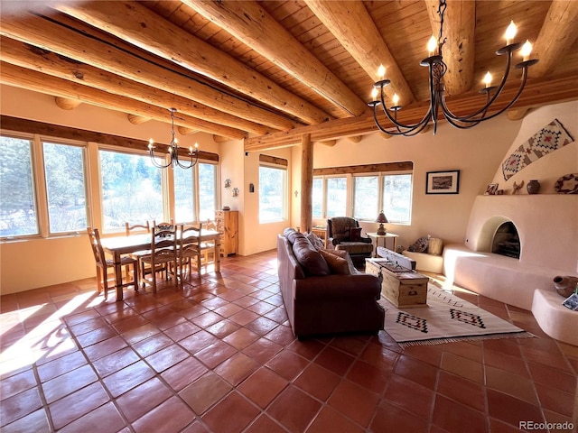 living room with a healthy amount of sunlight, an inviting chandelier, wood ceiling, and a large fireplace