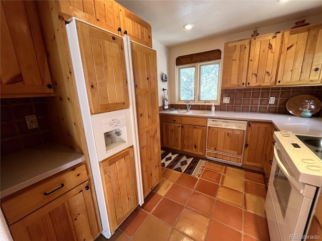 kitchen with white electric range, a sink, light countertops, tasteful backsplash, and paneled dishwasher