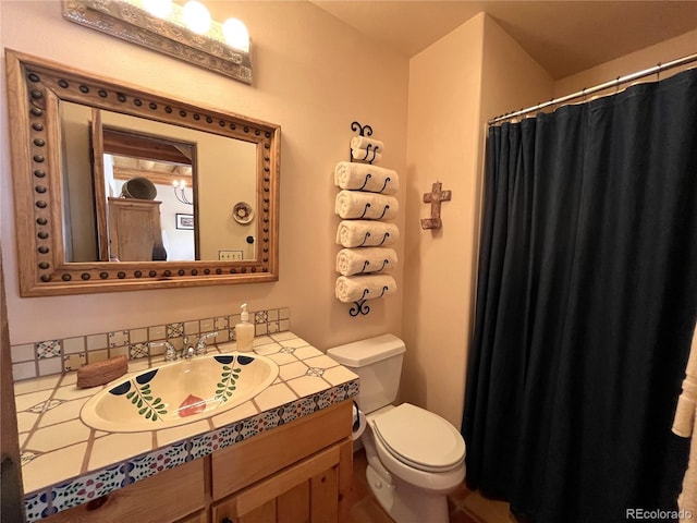 bathroom featuring toilet and vanity