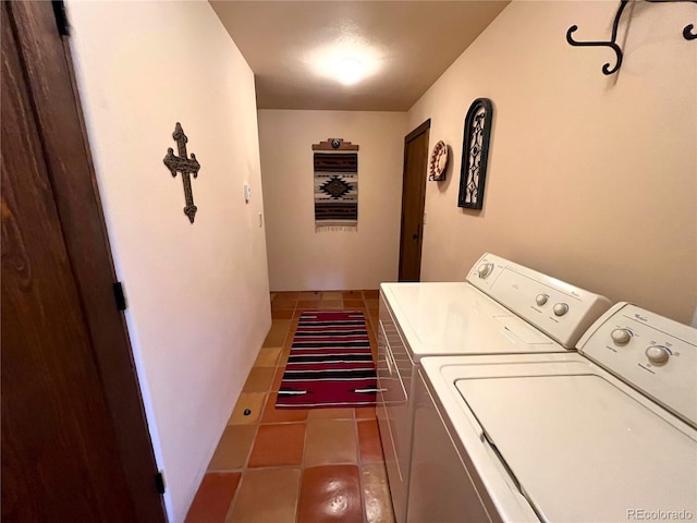 laundry area featuring washing machine and dryer, laundry area, and tile patterned floors