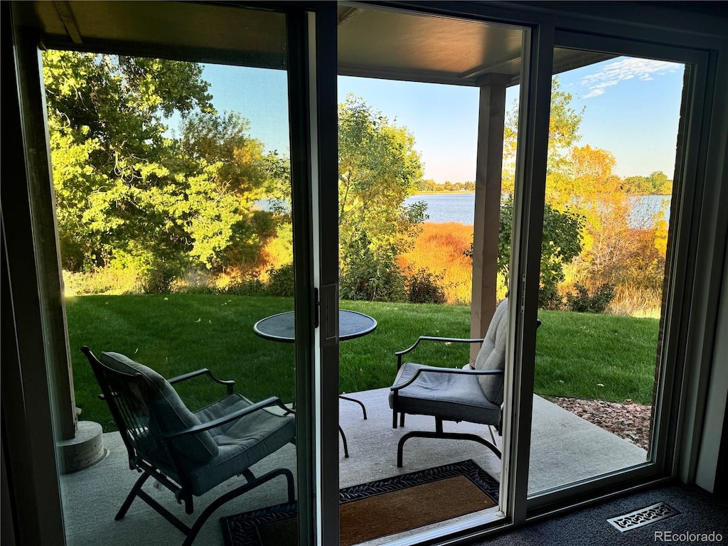 doorway to outside with a water view