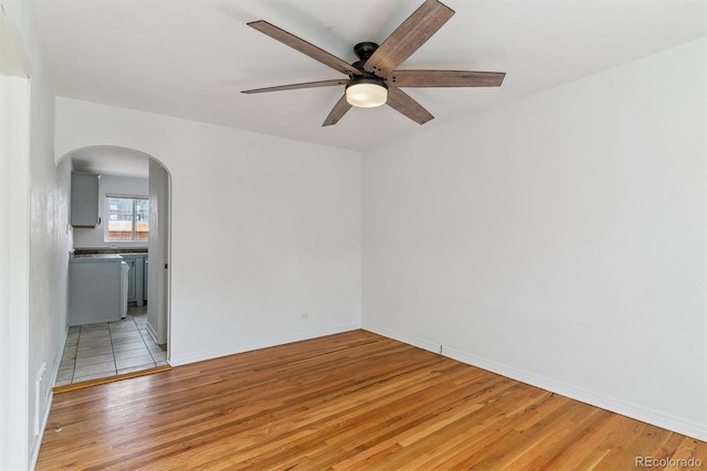 1804 Grove St, Denver, CO 80204 - empty room with light wood-style flooring, baseboards, arched walkways, and ceiling fan