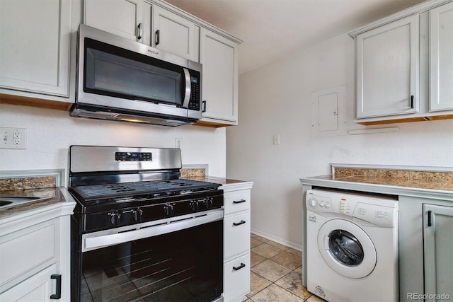 1804 Grove St, Denver, CO 80204 - kitchen with dark countertops, light tile patterned floors, washer / dryer, baseboards, and appliances with stainless steel finishes
