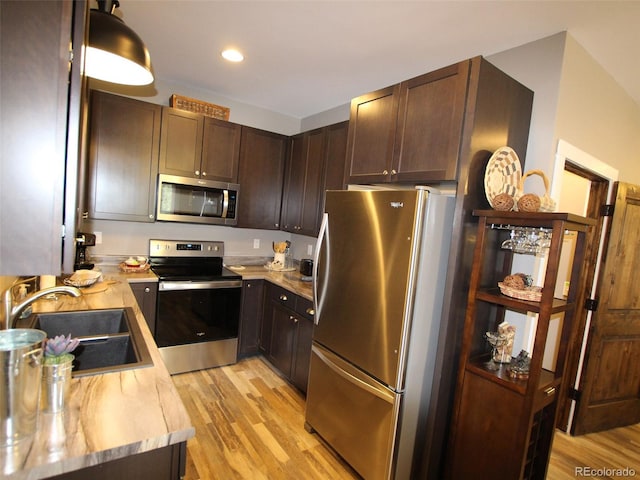219 Summitview Ln, Poncha Springs, CO 81201 - kitchen with stainless steel appliances, light wood-style flooring, light countertops, dark brown cabinetry, and recessed lighting
