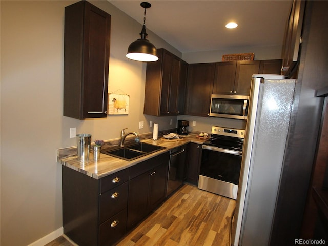 219 Summitview Ln, Poncha Springs, CO 81201 - kitchen featuring stainless steel appliances, light wood finished floors, dark brown cabinetry, decorative light fixtures, and recessed lighting