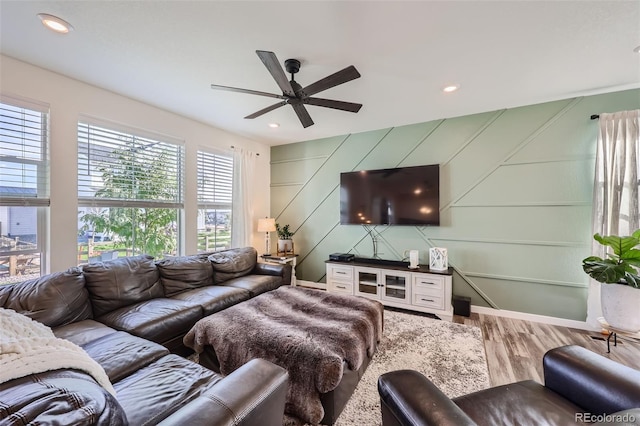 living room featuring hardwood / wood-style flooring and ceiling fan