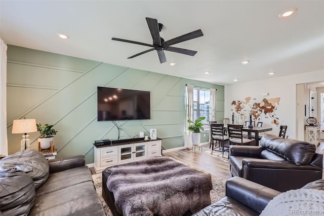 living room featuring ceiling fan and light wood-type flooring