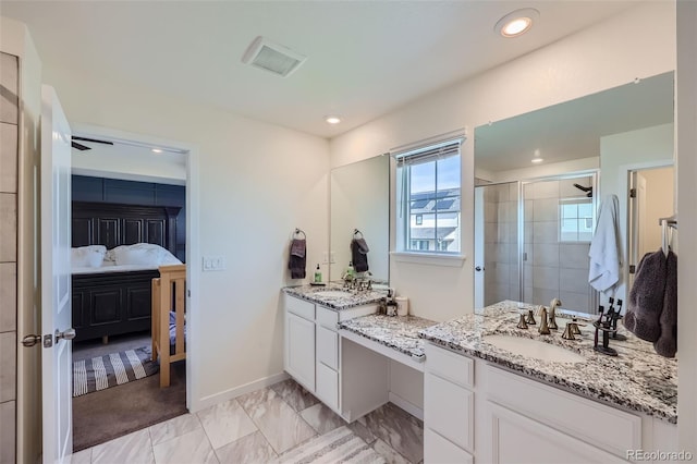 bathroom featuring an enclosed shower and vanity