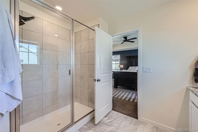 bathroom featuring walk in shower, ceiling fan, vanity, and a wealth of natural light