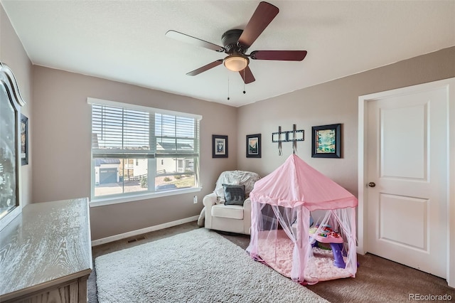 bedroom with dark colored carpet and ceiling fan