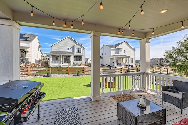 deck featuring area for grilling and a lawn