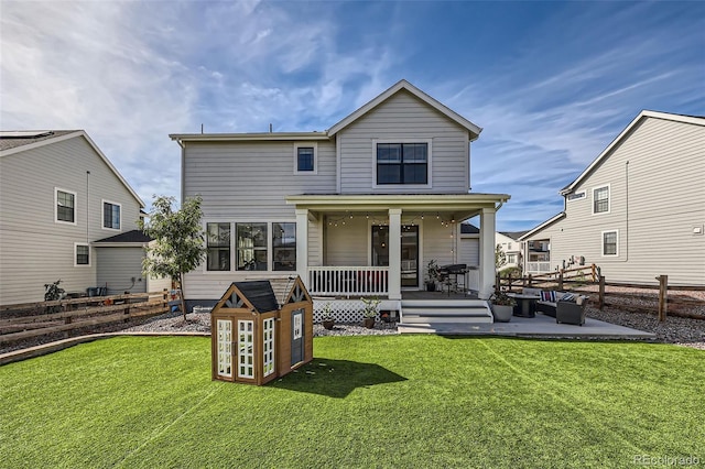 rear view of house with a patio area and a lawn