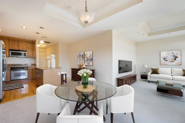1827 N Grant St Unit 1104, Denver, CO 80203 - dining space featuring a tray ceiling, light colored carpet, ornamental molding, and recessed lighting