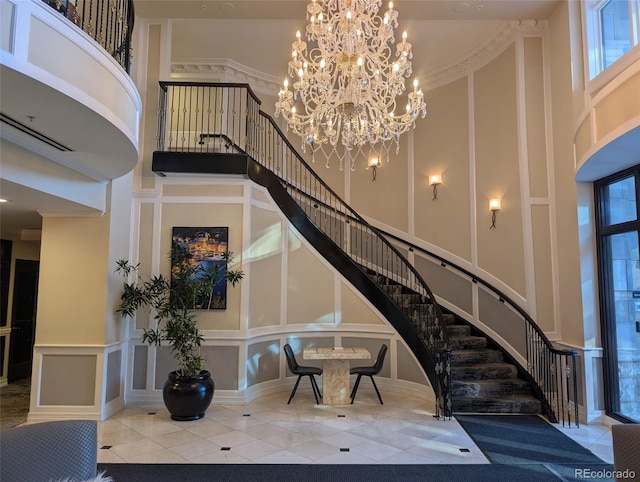 1827 N Grant St Unit 1104, Denver, CO 80203 - stairway featuring a high ceiling, a decorative wall, tile patterned flooring, and a chandelier