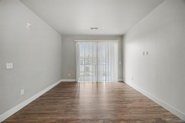 empty room with wood finished floors and baseboards