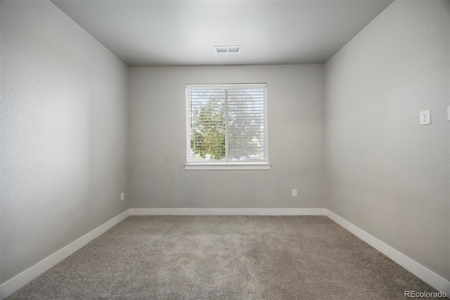 spare room with carpet flooring and baseboards