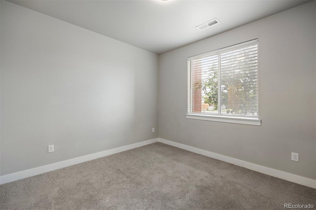 carpeted empty room with baseboards