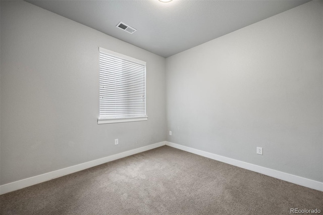 unfurnished room featuring carpet flooring and baseboards