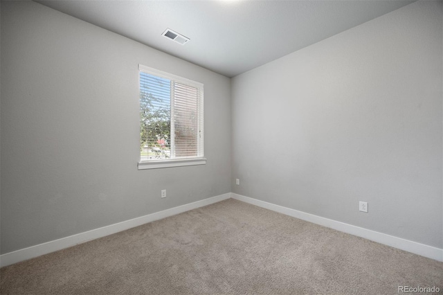 empty room with carpet and baseboards