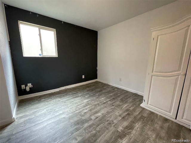 unfurnished room featuring dark hardwood / wood-style floors