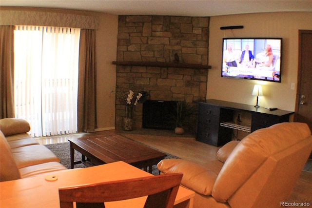 living room with a stone fireplace