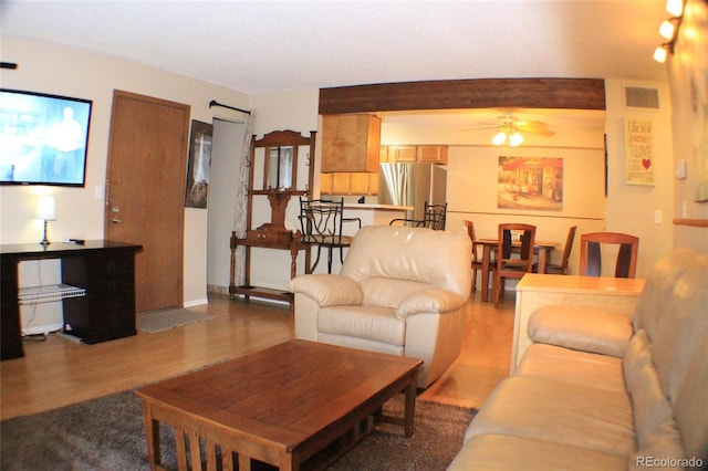 living room featuring hardwood / wood-style flooring and ceiling fan