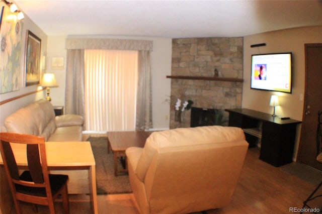 living room with hardwood / wood-style floors and a fireplace