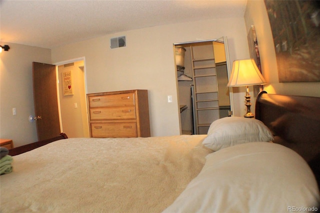 bedroom featuring a walk in closet and a closet