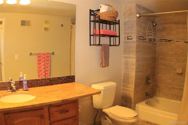 full bathroom featuring vanity, toilet, tiled shower / bath combo, and decorative backsplash